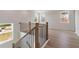 The staircase showcases a modern design with wood railing, rod iron spindles, and abundant natural light at 7525 Homer Dr, Cumming, GA 30028