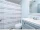 Charming bathroom with gray vanity, sleek fixtures, and clean modern finishes at 2410 Macon Sw Dr, Atlanta, GA 30315