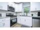 Bright kitchen featuring stainless steel appliances, granite countertops, and ample cabinet space at 2410 Macon Sw Dr, Atlanta, GA 30315