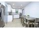 Open-concept kitchen with stainless steel appliances and adjacent dining area with seating for six at 2410 Macon Sw Dr, Atlanta, GA 30315