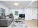 Bright living room with large windows, modern furniture, and stylish hardwood floors at 2410 Macon Sw Dr, Atlanta, GA 30315