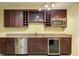 Wet bar area with a wine refrigerator, a stainless steel sink, and wooden cabinets at 5004 Duxford Se Dr, Smyrna, GA 30082