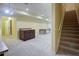 Spacious finished basement featuring neutral carpet, stairs, and a built-in cabinet for storage and entertaining at 5004 Duxford Se Dr, Smyrna, GA 30082