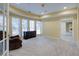 Basement featuring neutral carpet, a comfy chair, a dresser, and bright windows at 5004 Duxford Se Dr, Smyrna, GA 30082