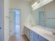 Bright bathroom featuring double sinks, a large mirror and tile floor at 5004 Duxford Se Dr, Smyrna, GA 30082