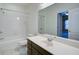 Bathroom with tile floors, a shower and tub, white vanity, and an open doorway at 5004 Duxford Se Dr, Smyrna, GA 30082