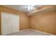 Bedroom with carpeted floor, ceiling fan and closet with white bi-fold doors at 5004 Duxford Se Dr, Smyrna, GA 30082