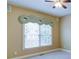 Bedroom featuring a ceiling fan, carpeted floors, and a window with decorative valance at 5004 Duxford Se Dr, Smyrna, GA 30082