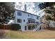 Spacious home exterior featuring a multilevel deck and landscaped yard at 5004 Duxford Se Dr, Smyrna, GA 30082