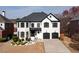 Stately two-story home with a classic black and white color scheme and a well-manicured front yard at 5004 Duxford Se Dr, Smyrna, GA 30082