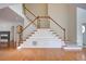 Bright foyer with hardwood floors, a staircase, and an arched doorway at 5004 Duxford Se Dr, Smyrna, GA 30082