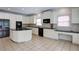 Bright kitchen features white cabinets, black appliances, granite counters, and tile floors at 5004 Duxford Se Dr, Smyrna, GA 30082