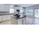 Bright kitchen with white cabinets, granite counters, tiled backsplash, and stainless steel appliances at 5004 Duxford Se Dr, Smyrna, GA 30082