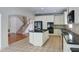 Eat-in kitchen featuring granite countertops, tiled floors, and a convenient center island with gas cooktop at 5004 Duxford Se Dr, Smyrna, GA 30082