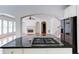 Kitchen with island cooktop and connecting views into living room and sunroom at 5004 Duxford Se Dr, Smyrna, GA 30082