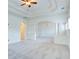 Spacious living room features plush carpet, a chandelier, and elegant architectural details at 5004 Duxford Se Dr, Smyrna, GA 30082