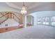 Open-concept living room with archways, carpet, a chandelier, and a staircase at 5004 Duxford Se Dr, Smyrna, GA 30082