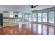 Sun-drenched living area boasts hardwood floors, ceiling fan, and arched openings to kitchen at 5004 Duxford Se Dr, Smyrna, GA 30082