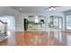 Open-concept living room flows into a bright kitchen with white cabinets and stainless steel appliances at 5004 Duxford Se Dr, Smyrna, GA 30082