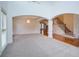Open-concept living room with archways, hardwood floors, a chandelier, and a staircase at 5004 Duxford Se Dr, Smyrna, GA 30082