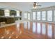 Spacious living room featuring hardwood floors, an open layout, and abundant natural light from large windows at 5004 Duxford Se Dr, Smyrna, GA 30082