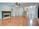 Cozy living room boasting a fireplace, hardwood floors, and seamless flow to the kitchen and foyer at 5004 Duxford Se Dr, Smyrna, GA 30082