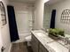 Modern bathroom with double granite vanity, white tub/shower and decorative accents at 5372 Tolar Rd, South Fulton, GA 30213