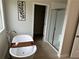 Bright bathroom featuring a soaking tub, walk-in shower, and modern finishes at 5372 Tolar Rd, South Fulton, GA 30213