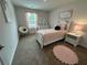 Well-lit bedroom features an accent chair, pink accents, and white furniture at 5372 Tolar Rd, South Fulton, GA 30213