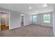 Large bedroom featuring carpet, neutral walls, and three windows providing natural light at 5372 Tolar Rd, South Fulton, GA 30213