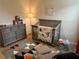 Well-decorated Bedroom with crib, dresser, rocking chair, and colorful rug at 5372 Tolar Rd, South Fulton, GA 30213