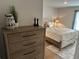 Comfortable bedroom with dresser, chess pieces and bed with soft linens at 5372 Tolar Rd, South Fulton, GA 30213
