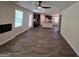 Open-concept living room with a cozy fireplace and hardwood floors, flowing to kitchen at 5372 Tolar Rd, South Fulton, GA 30213