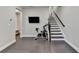 Finished basement area, with a staircase, exercise bike, and luxury vinyl plank flooring at 373 Via Secco Ln, Suwanee, GA 30024