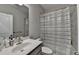 Bathroom includes a single vanity and shower with a white and gray curtain at 373 Via Secco Ln, Suwanee, GA 30024