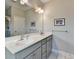 Bathroom with double sink vanity with large mirror at 373 Via Secco Ln, Suwanee, GA 30024