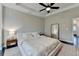 Spacious bedroom with tray ceiling, ceiling fan, and a large mirror at 373 Via Secco Ln, Suwanee, GA 30024