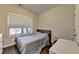 Bedroom with a bed, desk, and window featuring bright, natural light at 373 Via Secco Ln, Suwanee, GA 30024