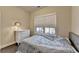Bedroom with a bed, dresser, and window featuring bright, natural light at 373 Via Secco Ln, Suwanee, GA 30024