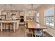 Dining room with a wooden table, chairs, modern lighting, and natural lighting at 373 Via Secco Ln, Suwanee, GA 30024