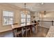 Dining room featuring a wooden table, chairs, modern chandeliers, and hardwood floors at 373 Via Secco Ln, Suwanee, GA 30024