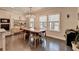 Dining room featuring hardwood floors, stylish chandelier, and natural light from the windows at 373 Via Secco Ln, Suwanee, GA 30024