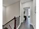 Hallway with hardwood flooring, wood banister and a view into another room at 373 Via Secco Ln, Suwanee, GA 30024