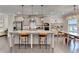 Kitchen with a large island, stainless steel appliances, modern lighting, and hardwood floors at 373 Via Secco Ln, Suwanee, GA 30024