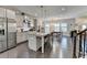 Kitchen with stainless steel appliances, granite countertops, modern lighting, and hardwood floors at 373 Via Secco Ln, Suwanee, GA 30024