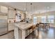 Kitchen with a large island, stainless steel appliances, modern lighting, and hardwood floors at 373 Via Secco Ln, Suwanee, GA 30024
