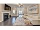 Comfortable living room with fireplace, elephant artwork, and hardwood flooring at 373 Via Secco Ln, Suwanee, GA 30024