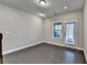 Neutral living area with hardwood floors, a bright window, and a glass door at 373 Via Secco Ln, Suwanee, GA 30024