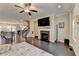 Spacious living room has hardwood floors, a fireplace, and views into other rooms at 373 Via Secco Ln, Suwanee, GA 30024
