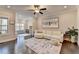 Bright living room with hardwood flooring, area rug, and an elephant painting at 373 Via Secco Ln, Suwanee, GA 30024